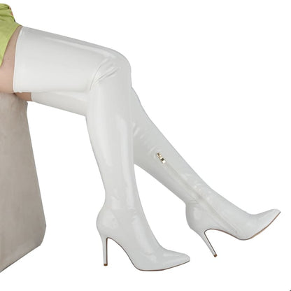 White thigh-high stiletto boots with pointed toes.