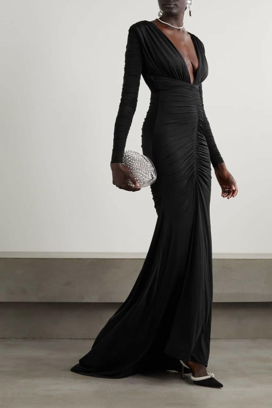 Long black evening gown with a plunging neckline and ruched detailing.