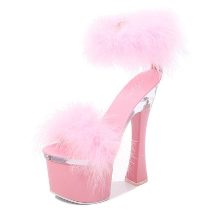 Pink platform high heel shoe with fluffy fur trim.