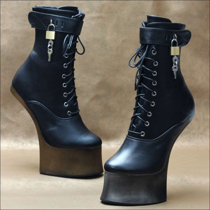 Pair of black high-heeled platform boots with laces and padlocks.