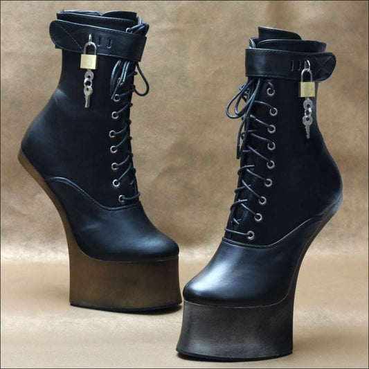 Pair of black high-heeled platform boots with laces and padlocks.