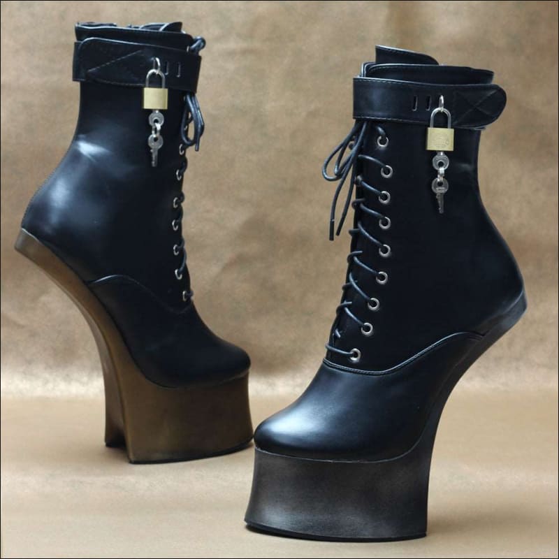 Pair of black high-heeled platform boots with laces and padlocks.