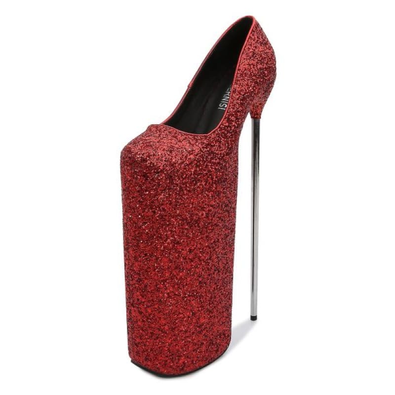 Extremely high-heeled red glittery platform shoe with an exaggerated sole.