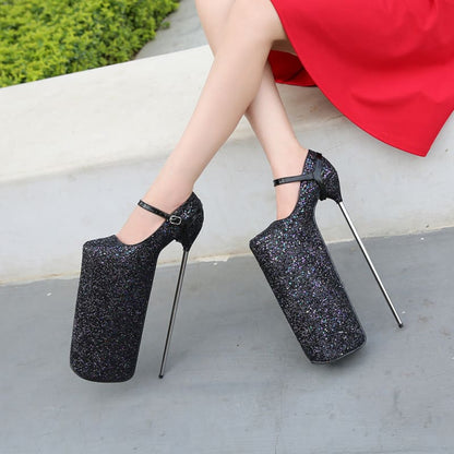 Extremely high platform heels with glittery black finish and metal stiletto spikes.