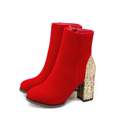 Pair of red ankle boots with glittery gold block heels.