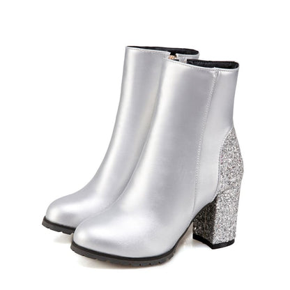 Pair of silver ankle boots with glittery block heels.