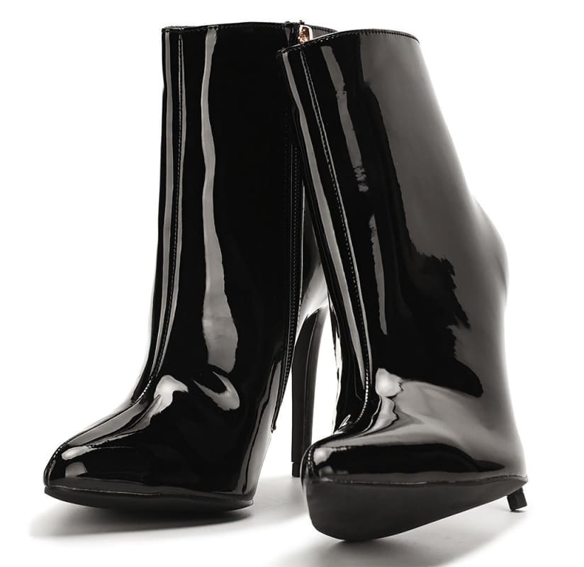 Pair of glossy black high-heeled ankle boots with pointed toes.