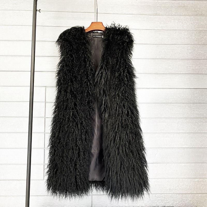 Black shaggy faux fur vest hanging on a wooden hanger.