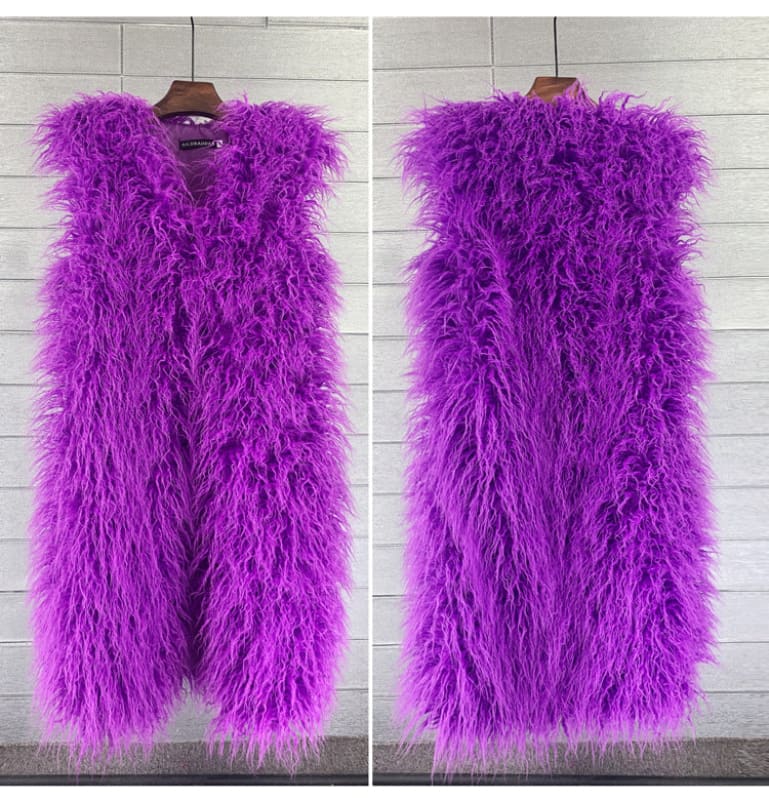 Vibrant purple furry sleeveless vest hanging on a wooden hanger.