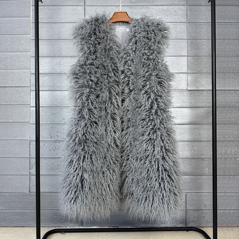 Fluffy gray faux fur vest hanging on a clothing rack.