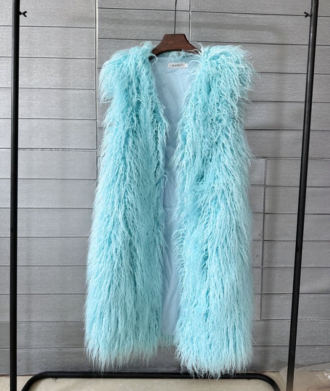 Fluffy, light blue faux fur vest hanging on a wooden hanger.