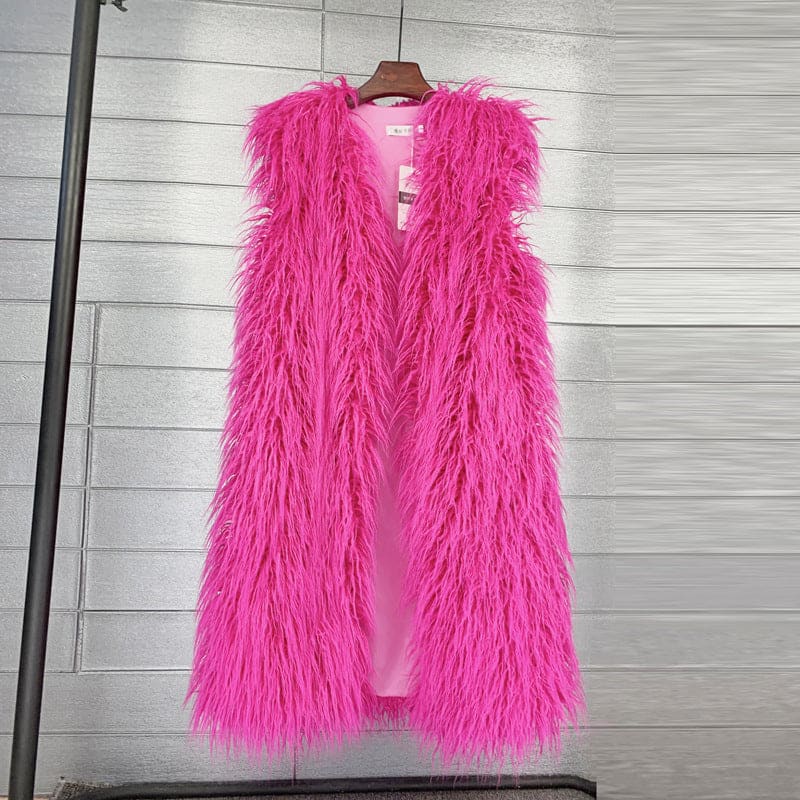 Bright pink fluffy sleeveless vest or gilet hanging on a wooden hanger.