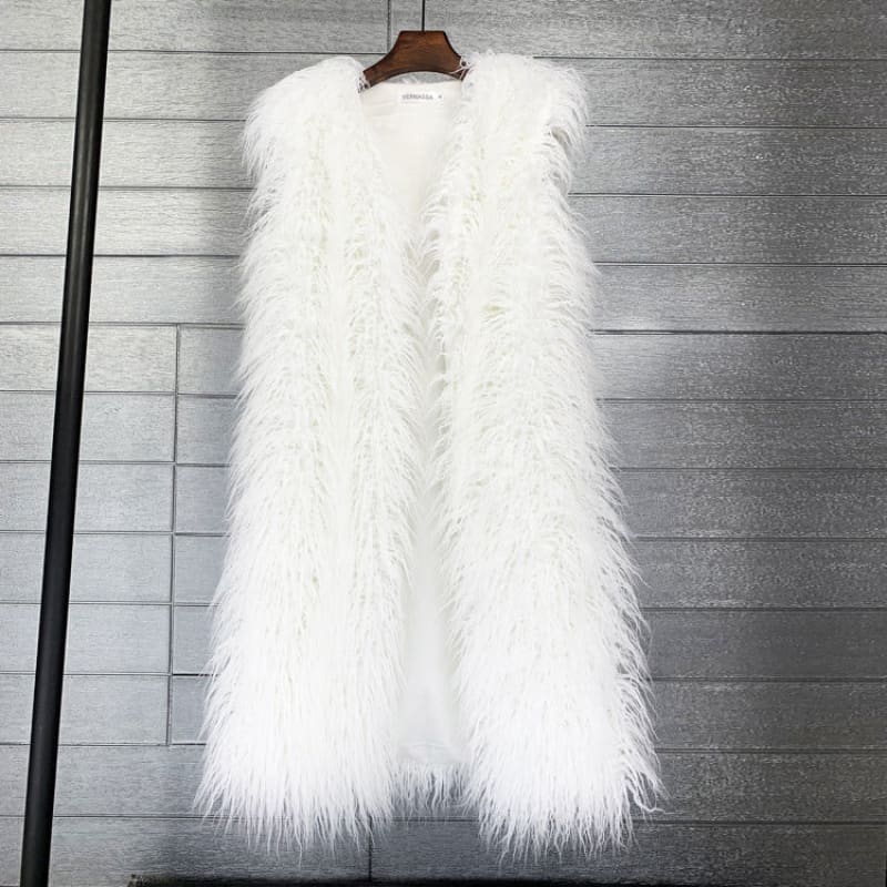 Fluffy white faux fur vest hanging on a wooden hanger.