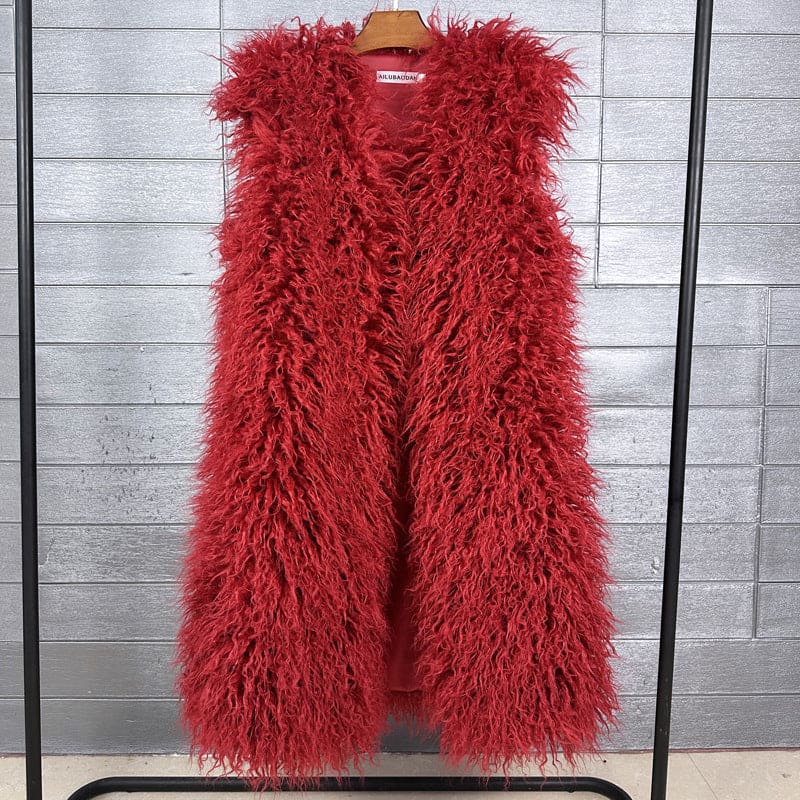 Bright red, fluffy faux fur vest hanging on a wooden hanger.