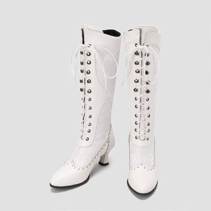 Pair of white leather lace-up knee-high boots with heels.