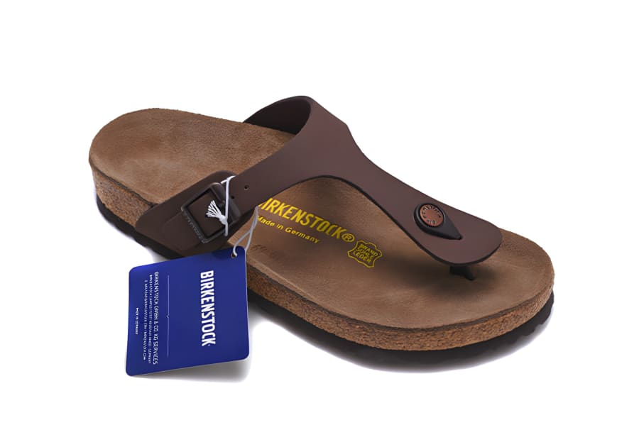 Brown leather thong sandal with a cork footbed and attached blue tag.