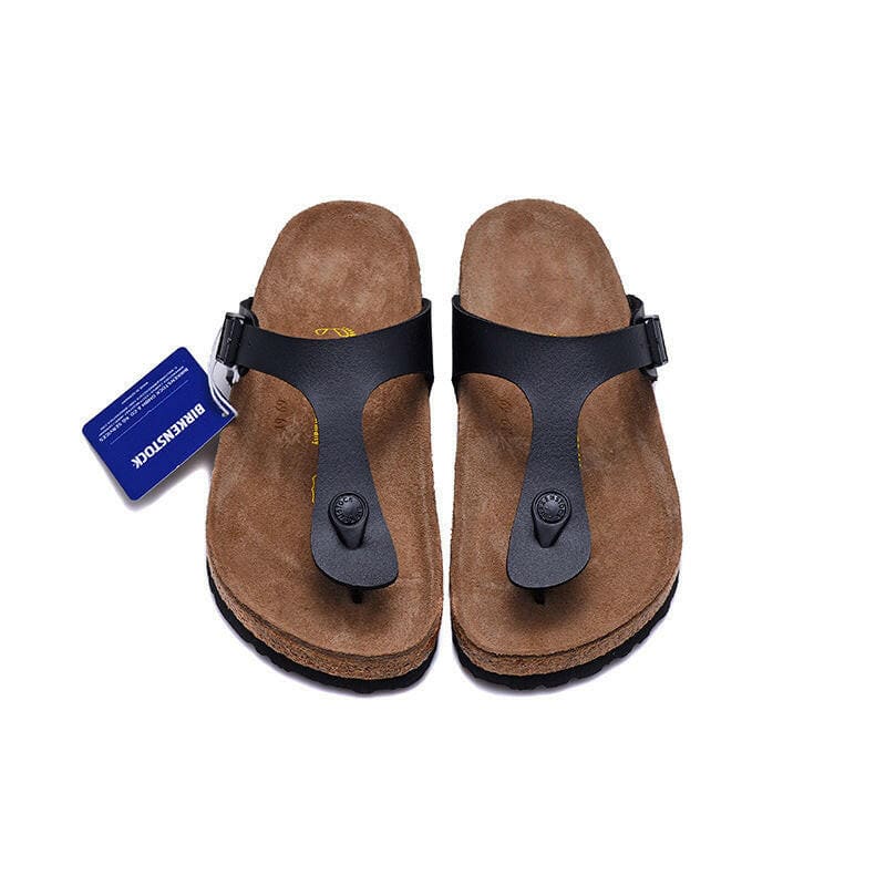 Pair of dark blue thong sandals with brown cork footbeds and a blue tag attached.