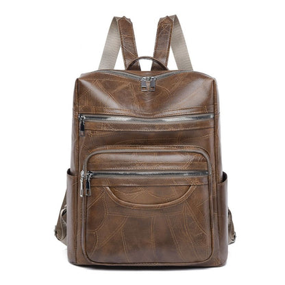 Brown leather backpack with multiple zippered compartments and adjustable straps.