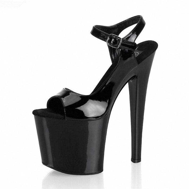 Black patent leather platform high heel sandal with an ankle strap.