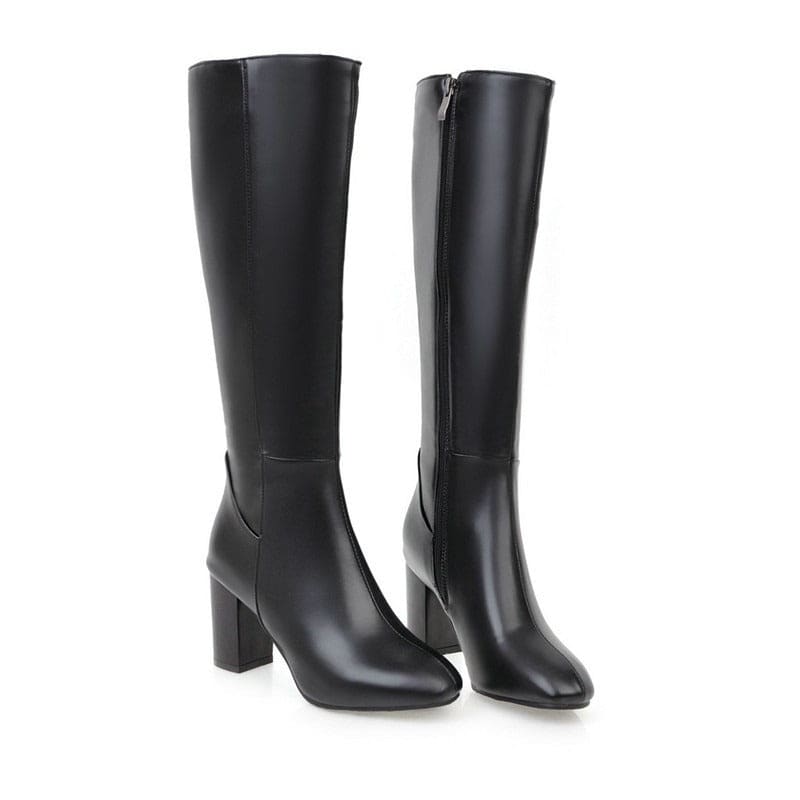 Pair of black leather knee-high boots with block heels.