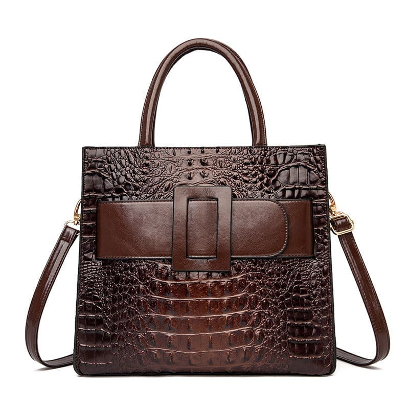 Brown leather handbag with crocodile-embossed texture and a prominent front buckle.