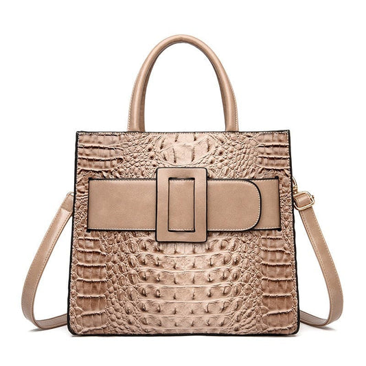 Beige leather handbag with crocodile-textured pattern and a prominent buckle detail.