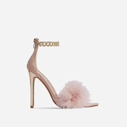 High-heeled sandal with a fluffy pink strap and gold ankle chain.