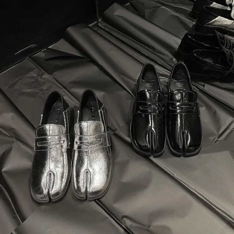 Two pairs of genuine leather split toe block loafers in metallic silver and black.