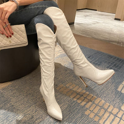 White knee-high stiletto boots with a pointed toe.