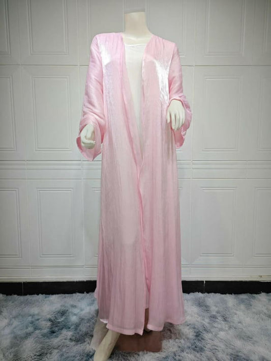 Long, pale pink nightgown or robe with long sleeves displayed on a mannequin.