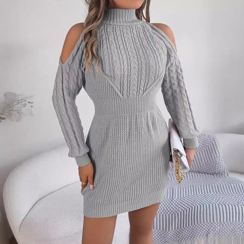 Gray knitted cold-shoulder sweater dress with a turtleneck and cable pattern.