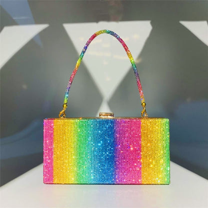 Rainbow-colored, glittery rectangular handbag with a matching arched handle.