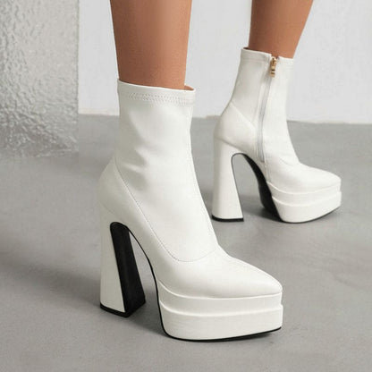 White platform ankle boots with chunky high heels.