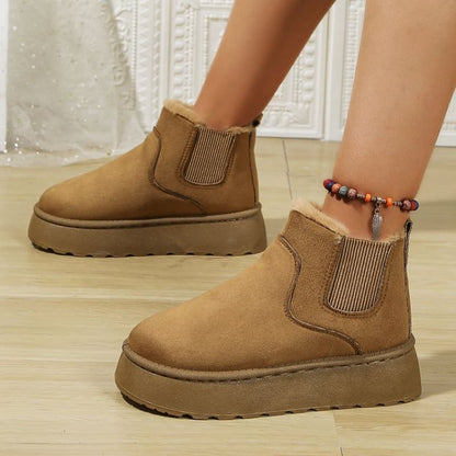 Pair of tan suede platform ankle boots with elastic side panels.