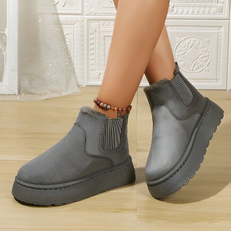 Gray ankle boots with thick platform soles and elastic side panels.