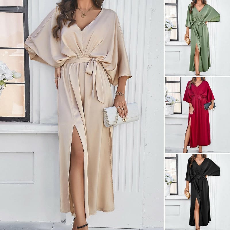 Flowing wrap dress with wide sleeves, belted waist, and side slit.