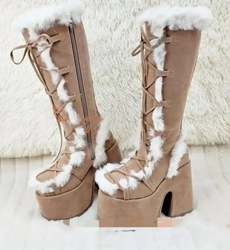 Tan faux fur round toe platform boots with white trim and lace-up front for winter.